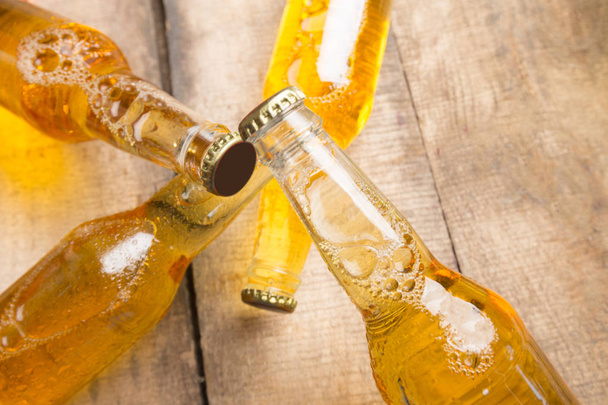 Beer bottles on a wooden table . - Zdjęcie, obraz