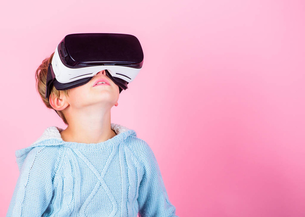 Explore alternative reality. Cyber space and virtual gaming. Virtual reality future technology. Discover virtual reality. Kid boy wear vr glasses pink background. Child boy play virtual reality game - Photo, image