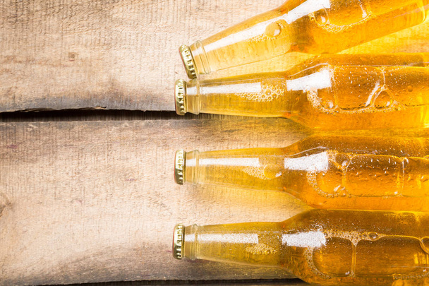 Beer bottles on a wooden table . - Foto, afbeelding