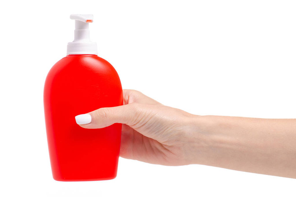 Red bottle with soap dispenser in hand - Photo, image