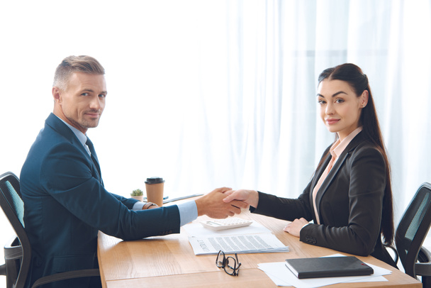 business partners shaking hands at workplace in office - Foto, Bild