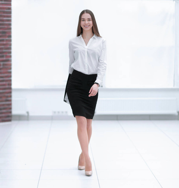 Beautiful confident businesswoman walking through a corridor - Zdjęcie, obraz