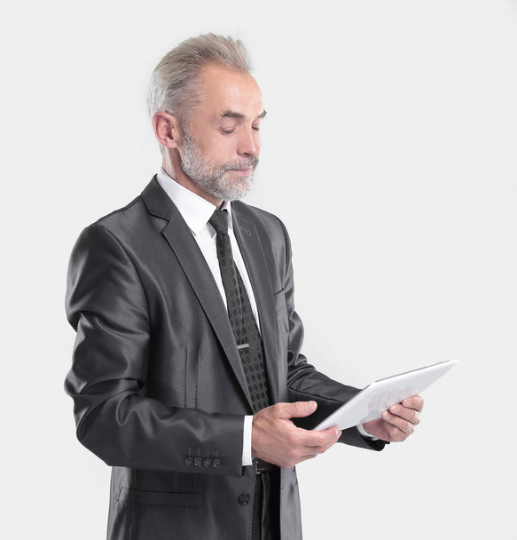 modern businessman reading text on a digital tablet.isolated on grey background - Photo, image