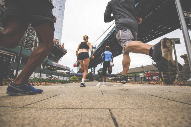 Group of urban runners running on the street in New york city, conceptual series about sport and fitness - Φωτογραφία, εικόνα