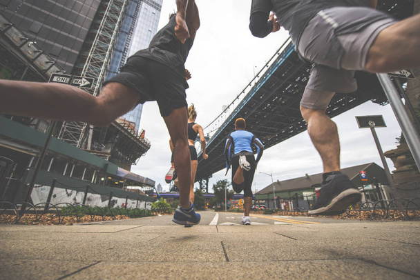 Group of urban runners running on the street in New york city, conceptual series about sport and fitness - Photo, image