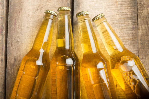 Beer bottles on a wooden table . - Foto, Imagem