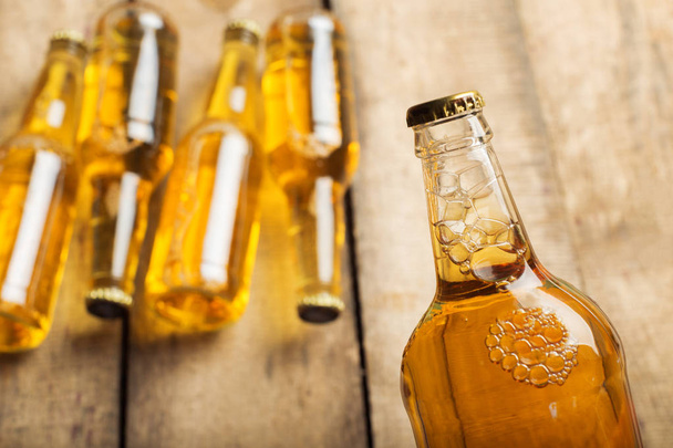 Beer bottles on a wooden table . - Fotografie, Obrázek