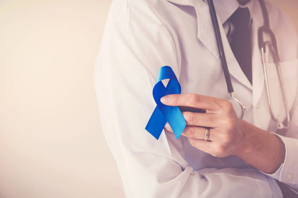 Doctor hand holding Light blue ribbon, Prostate Cancer Awareness - Fotó, kép