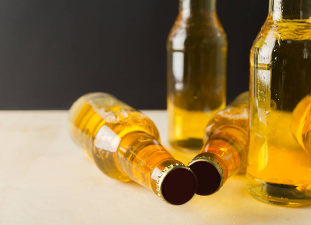 Beer bottles on a wooden table . - Фото, зображення