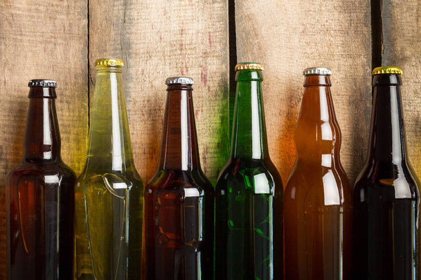Beer bottles on a wooden table . - Foto, Imagen