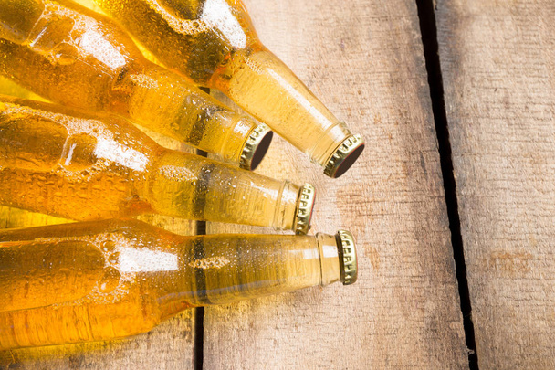 Beer bottles on a wooden table . - Foto, afbeelding