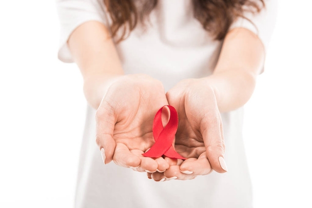 cropped shot of woman holding aids awareness red ribbon isolated on white - Fotografie, Obrázek