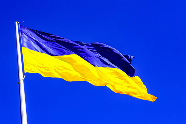 De grootste geel en blauw staat vlag van Oekraïne op een vlaggenmast 30 meter in de Oekraïense stad Dnipro (Dnjepropetrovsk, Dnjepropetrovsk, Dnepr) - Foto, afbeelding