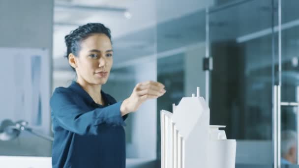 Female Architectural Designer Adds Component to a Building Model, She Works on a City District Urban Planning Project. Beautiful Woman in Stylish Office. - Footage, Video