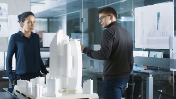 Two Young and Progressive Architectural Engineers Work on a Building Model that is Part of a Big New Urban Planning Project. Beautiful Smart People in a Fashionable Office. - Footage, Video