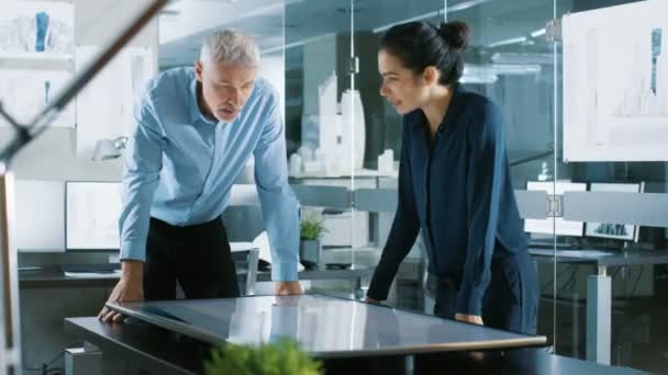 Senior Male and Young Female Architectural Designers Draw Building Concept on a Graphics Tablet Display Vertical Touchscreen Table. They Use Gestures for Zooming Project Model. - Footage, Video