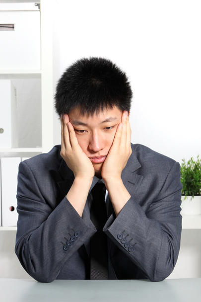 Despondent Asian businessman - Фото, изображение