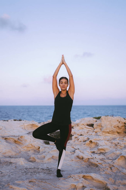 Retrato de una hermosa joven practicando yoga en la playa
 - Foto, Imagen