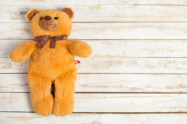 top view of Teddy bear on wooden background  - Zdjęcie, obraz