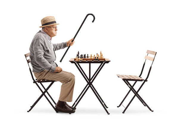Angry mature man playing chess isolated on white background - Fotoğraf, Görsel