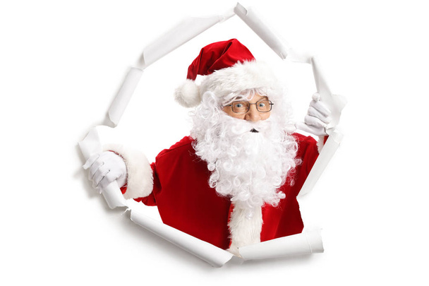 Santa Claus emergiendo de un agujero de papel aislado sobre fondo blanco
 - Foto, imagen