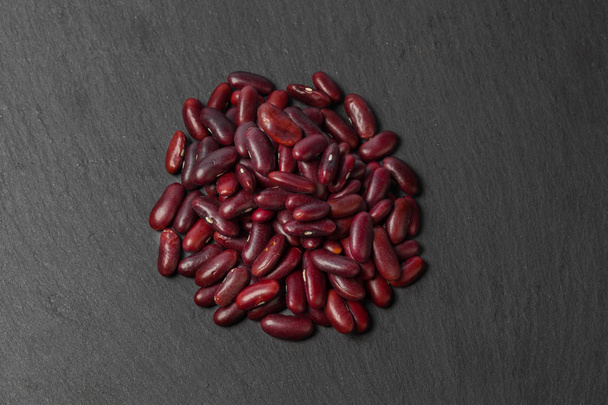 red beans on black wooden table - Φωτογραφία, εικόνα