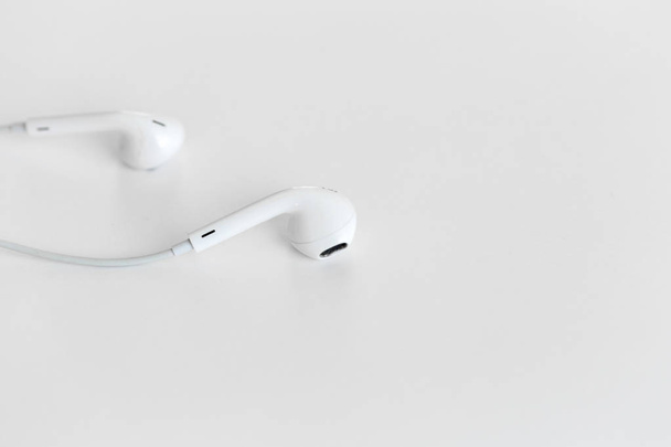 White earphones on background,close up - Foto, afbeelding
