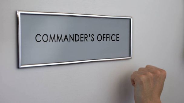 Commander office door, hand knocking closeup, military authority, leadership - Foto, imagen