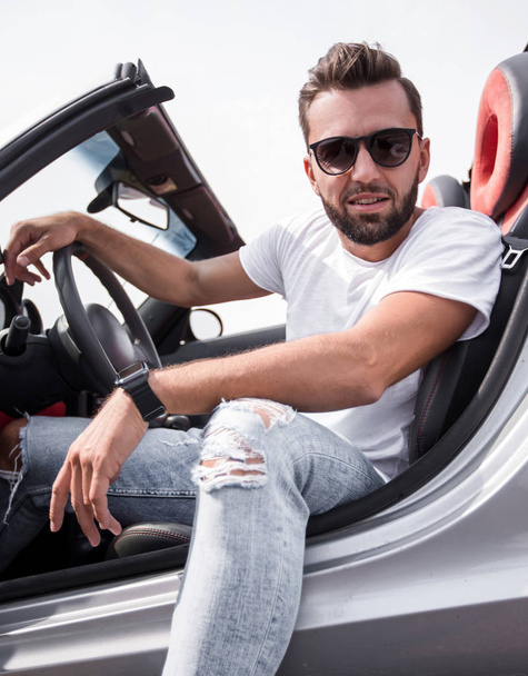 close up.stylish young man sitting in a luxury car - Foto, Imagem