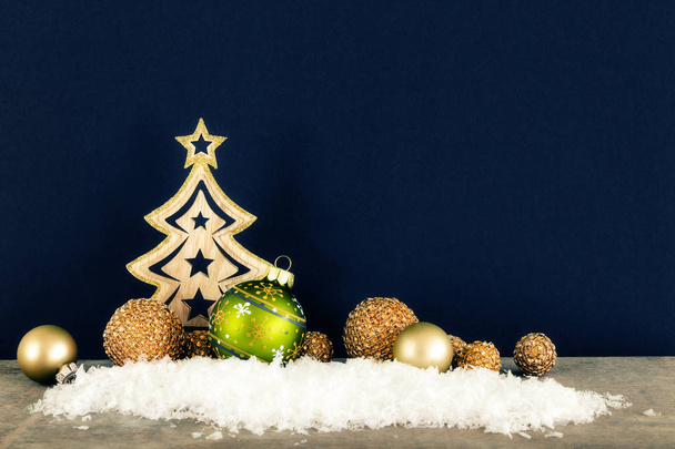 Christmas decoration dark background with wooden tree glass balls and snow - Photo, Image