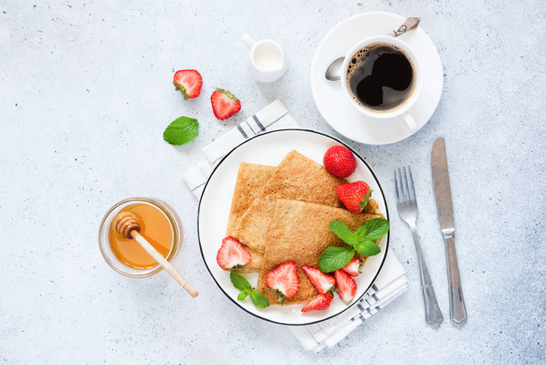 Crepes or blinis with strawberry, coffee cup and honey - Fotoğraf, Görsel