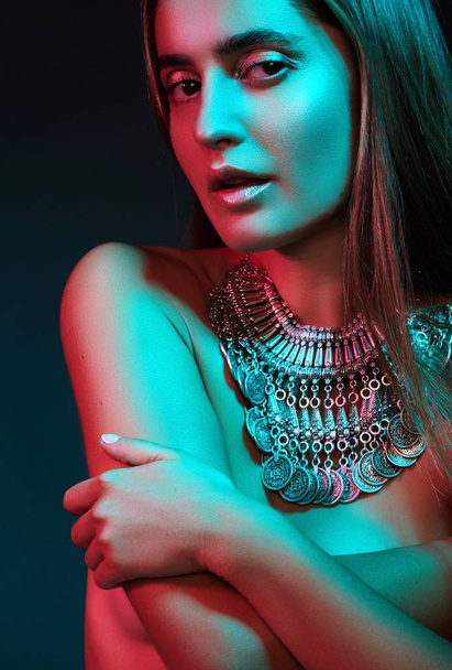 Beautiful woman in a necklace. Model in jewelry from silver. Beautiful indian jewellery. Bright lights photo effect - Φωτογραφία, εικόνα