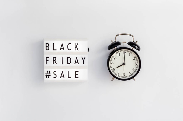 Creative Top view flat lay promotion composition Black friday sale text on lightbox alarm clock white background copy space Template Black friday sale mockup fall thanksgiving promotion advertising - Photo, image