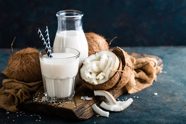 Fresh coconut milk in glass and bottle, vegan non dairy healthy drink - Fotografie, Obrázek