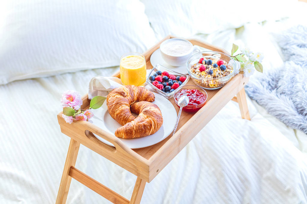breakfast in bed with fruits and pastries on a tray - Φωτογραφία, εικόνα