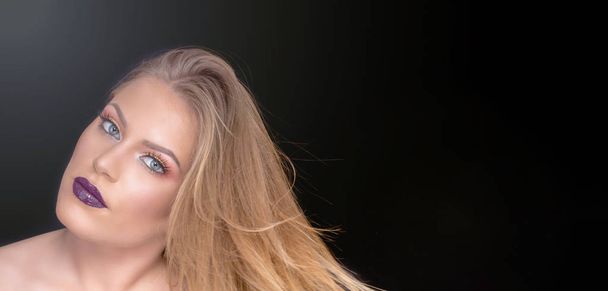 Portrait of beautiful young woman with long colored blonde hair and bright make-up - Fotografie, Obrázek