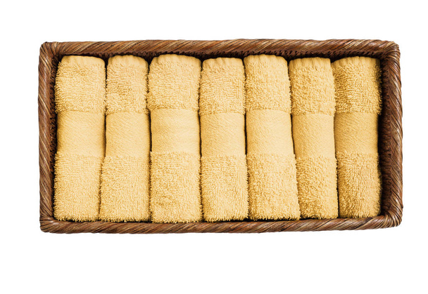 Pequenas toalhas amarelas em cesta isoladas sobre fundo branco. Vista superior
 - Foto, Imagem