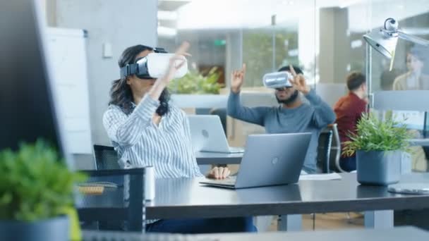 Female Virtual Reality Engineer/ Developer Wearing Virtual Reality Headset Creates Content With Her Colleagues. Bright Young People Work on the Augmented & Mixed Reality Project. - Filmmaterial, Video