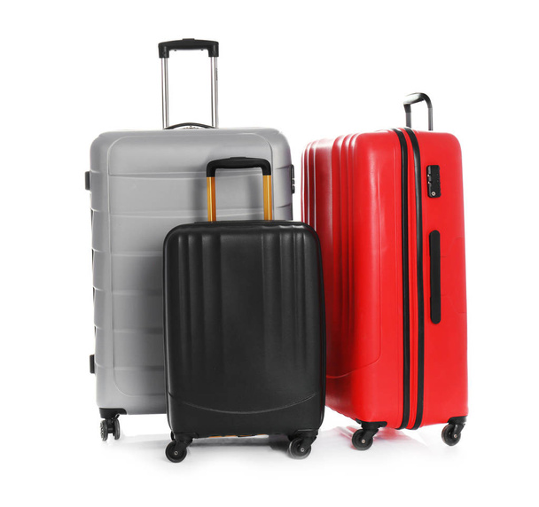 Modern suitcases for travelling on white background - Fotó, kép