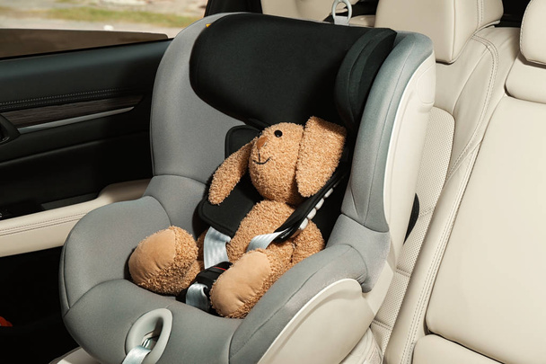 Safety seat for baby with cute toy rabbit - Фото, изображение
