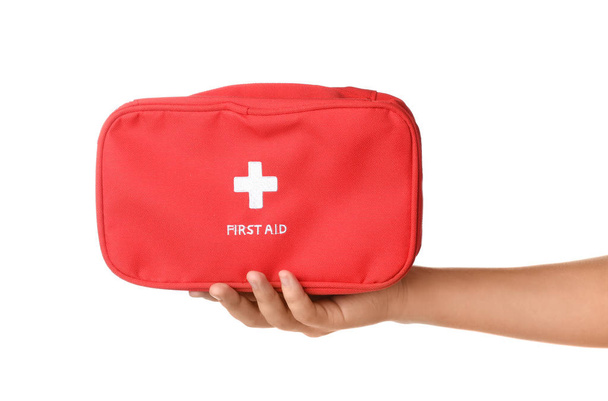 Woman holding first aid kit on white background - Foto, afbeelding