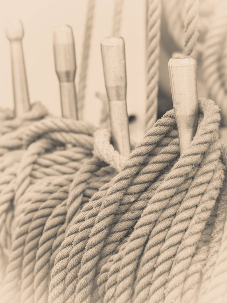 Old fashioned harbor marina sail boat ropes. Yachting details and objects concept. - Foto, afbeelding