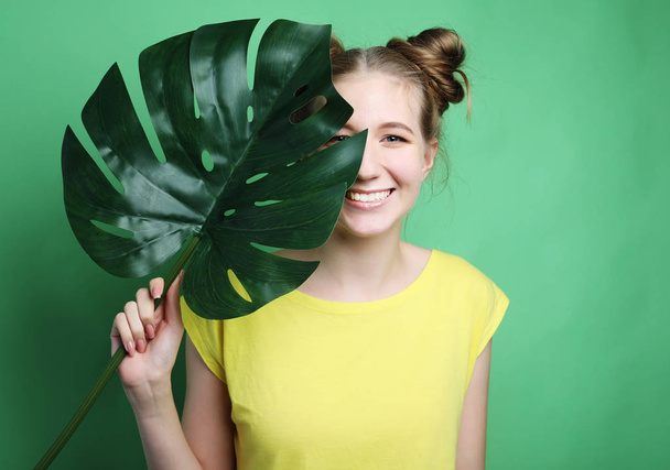 lifestyle and people concept: young woman with a leaf - Фото, изображение
