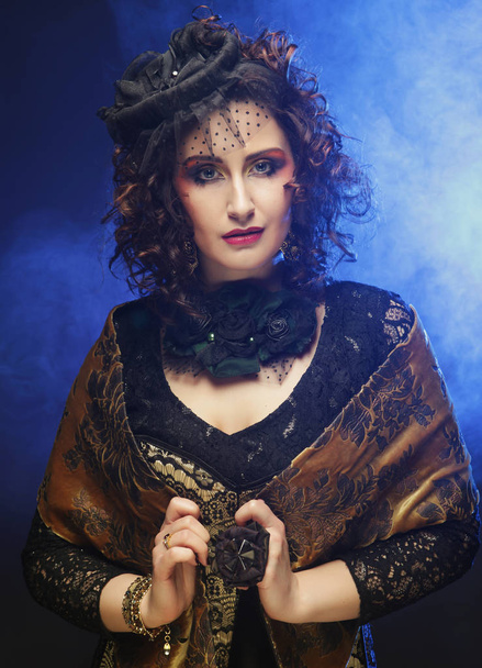 Beautiful lady with artistic make-up. Curly hair. Luxury style. Studio shoot. - 写真・画像