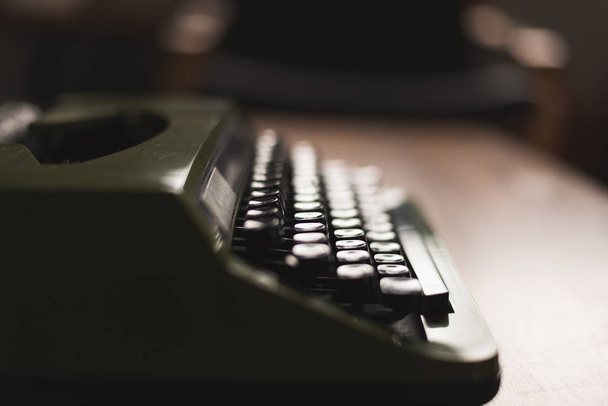 vintage typewriter in green color on the desk - Photo, image