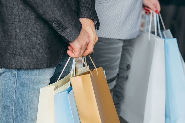 shopping discounts couple multiple bags hands - Foto, Bild