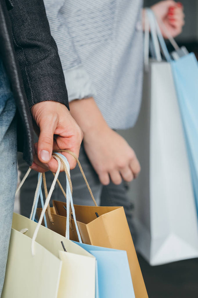 shopping consumerism man hand holding bags - Fotó, kép