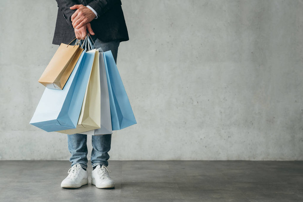 holiday sale shopping consumerism man hold bags - 写真・画像