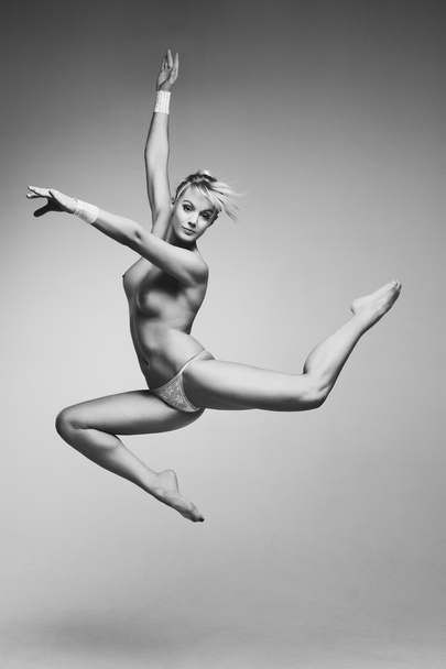 Young naked woman jumping - 写真・画像
