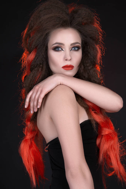 fashion portrait of beautiful young woman with long hair. Red tress hair girl with make-up over black background - Fotografie, Obrázek